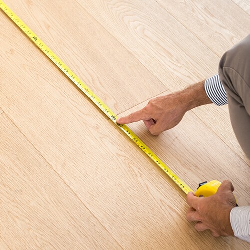 Man Measuring Floor | Roberts Carpet & Fine Floors